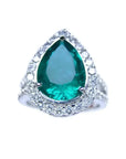 Anillo de compromiso con esmeralda corte pera certificada por GIA rodeada de diamantes naturales en oro blanco.