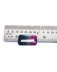 Rectangular emerald cut watermelon tourmaline with vibrant red-orange and deep blue-green colors, next to a ruler.