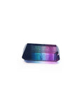 Rectangular emerald cut watermelon tourmaline with vibrant red-orange, bluish-green, and purple hues.