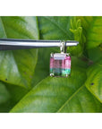 Brazilian bicolor tourmaline watermelon solitaire pendant in 14K yellow gold, held by tweezers.