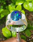 Men's sterling silver ring with a sparkling blue, red, and green Welo black opal.