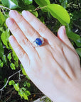 Men's sterling silver ring with a sparkling blue Welo black opal, accented by red and green flashes.