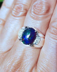 Men's sterling silver ring with a sparkling blue Welo black opal.