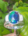 Men's sterling silver ring with a sparkling blue, red, and green Welo black opal.