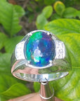 Men's sterling silver ring with a sparkling blue, red, and green Welo black opal.