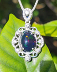 Multicolor 3.45 ct. Welo Ethiopian black opal pendant in ornate 925 silver with cubic zirconia.