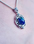 Multicolor Welo Ethiopian black opal pendant in ornate sterling silver with CZ accents.
