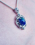 Multicolor Welo Ethiopian black opal pendant in ornate sterling silver with CZ accents.