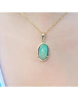 2.86 ct. oval Ethiopian opal pendant with bluish-green hues, prong set in 14K yellow gold on a chain.