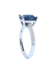 18K white gold ring with a radiant-cut deep blue sapphire and diamond accents.