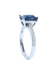 18K white gold ring with a radiant-cut deep blue sapphire and diamond accents.