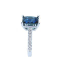 18K white gold ring with a radiant-cut blue sapphire and diamond accents.