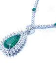 Pear cut emerald necklace with double diamond halo, 18K white gold chain with emerald accents.