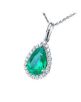 18K white gold pear-shaped emerald pendant with a halo of natural diamonds on a delicate chain.
