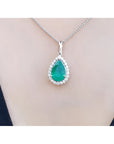 18K white gold pear-shaped emerald pendant with a halo of natural diamonds on a chain.