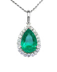 Emerald green teardrop pendant with diamond accents on a front position showing toside view