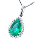 Emerald green teardrop pendant with diamond accents on a left side position topside visible.