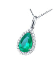 18K white gold pear-shaped emerald pendant with a halo of natural diamonds on a delicate chain.