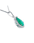 18K white gold pear-shaped emerald pendant with a halo of natural diamonds on a chain.