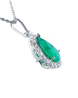 White gold necklace with a teardrop emerald pendant on a right-side gallery profile view