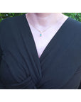 May's birthstone tear drop emerald necklace: this natural Muzo Colombian gem is dangling from a chevron design in 14k yellow gold