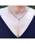 Emerald Kisses and Hugs necklace with a medium bluish green square emerald and gold X & O links.