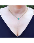 Emerald Kisses and Hugs necklace with a medium bluish green square emerald and gold X & O links.