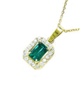 18k yellow gold pendant with a vibrant emerald-cut Colombian emerald and diamond halo.