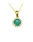 Round deep green Colombian emerald necklace with halo diamonds in 14k yellow gold.