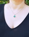 14K white gold cluster necklace with natural Colombian emeralds and diamonds in a 4-leaf clover design.