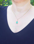 woman wearing a Colombian emerald necklace pear cut natural 3.30 carats crafted in 18k yellow gold