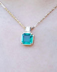 18k yellow gold necklace with an Asscher cut colombian emerald gemstone pendant top accent diamond.