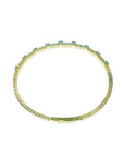 Flexible 14K yellow gold bangle bracelet with square-cut emeralds and accent diamonds.