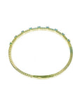 Flexible 14K yellow gold bangle bracelet with square-cut emeralds and accent diamonds.