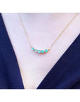 Sparkling Green Fire Emerald Necklace with five round cut emeralds on a 14K gold chain.