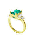 14K yellow gold ring with a rectangular emerald-cut deep bluish-green emerald and three accent diamonds on each side.