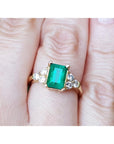 A colombian emerald-cut emerald ring for ladies on a finger.
