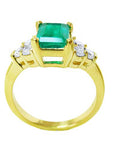 This image displays a yellow gold emerald and side diamond ring, displaying the top, gallery and band profile.