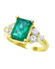 Yellow gold emerald rings and diamond accents on a white background.