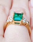 Gold ring with a genuine colombian emerald on a finger.