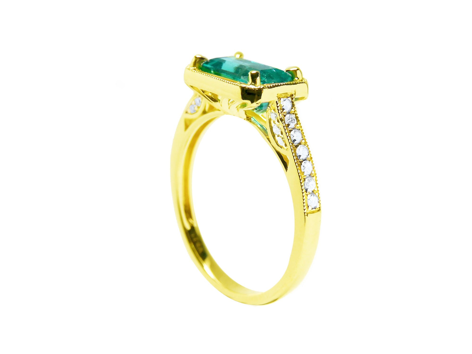 From a partial side angle, this emerald ring reveals the top setting, a portion of the gallery, and the band design.
