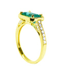 From a partial side angle, this emerald ring reveals the top setting, a portion of the gallery, and the band design.