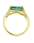 The lateral position of this emerald ring displays the top setting, gallery and band profile.