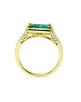 The lateral position of this emerald ring displays the top setting, gallery and band profile.