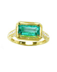 This 14k gold genuine colombian emerald ring displays the centered gemstone in prong set and accent diamonds.