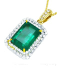 Emerald pendant with a double halo diamond with gold chain on a white background