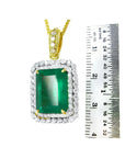 18K yellow gold emerald-cut pendant with a deep bluish-green emerald and double halo natural diamonds.