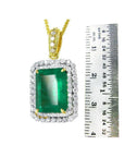 18K yellow gold emerald-cut pendant with a deep bluish-green emerald and double halo natural diamonds.