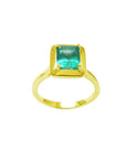 1.22 carat emerald-cut Muzo Colombian emerald solitaire ring in 14K yellow gold.