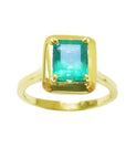 The top view of this solitaire emerald ring displays the rectangular emerald-cut emerald and sideway the ting's band.
